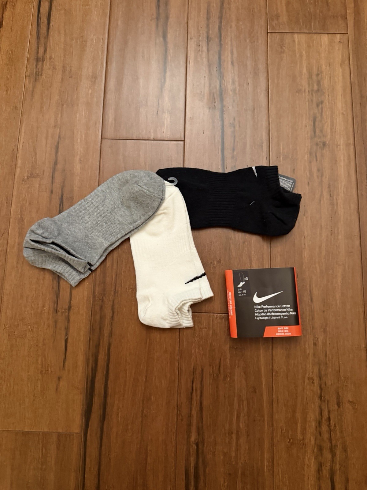 3-pack of Nike Performance Cotton sock in assorted grey, white, and black colors